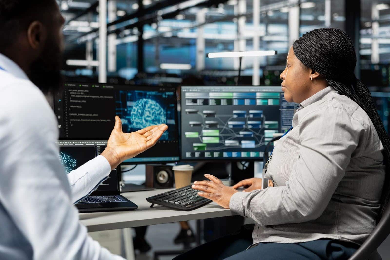 IT professionals working on system monitoring and cybersecurity solutions in office environment